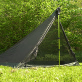 DD Superlight Pathfinder Mesh Tent set up in nature with hiking pole, showcasing insect mesh design for solo campers.